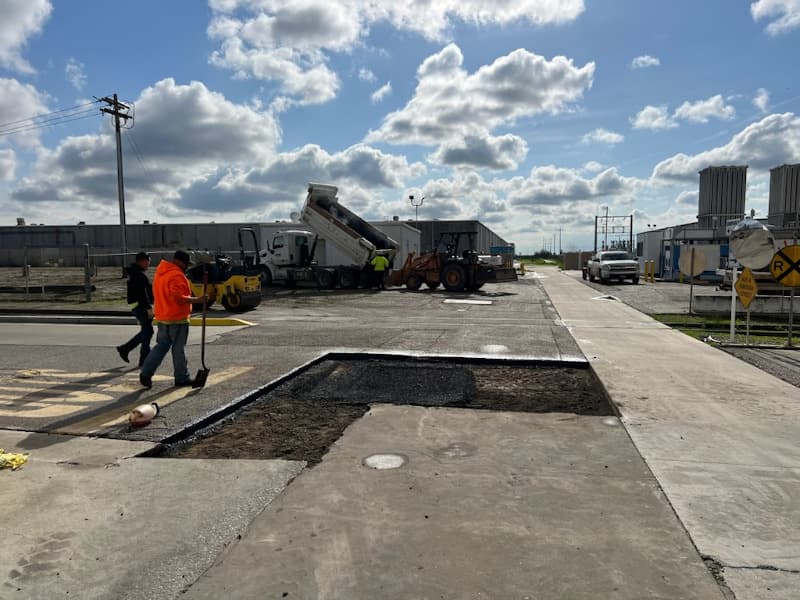 Asphalt being repaired in a parking lot