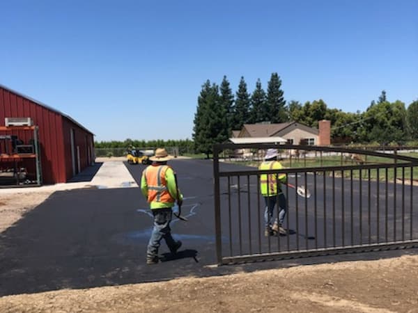 new asphalt driveway being installed