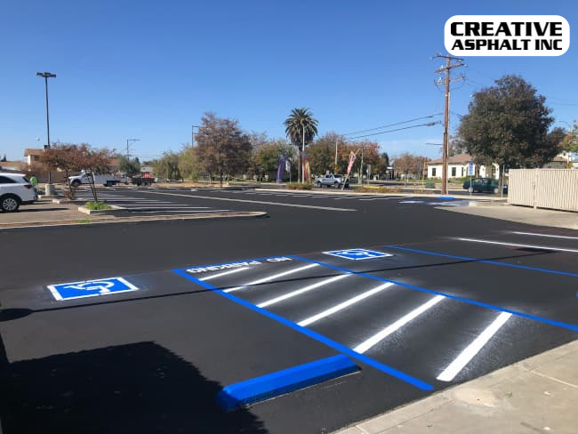 parking lot that has been seal coated and has new ADA parking lot striping