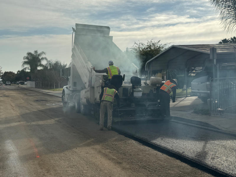 New asphalt being installed on street in Reedley, CA