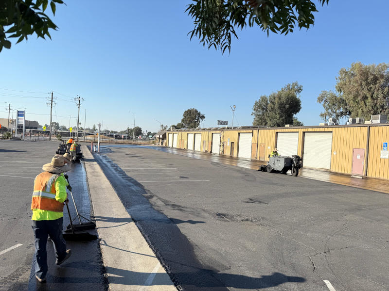 Crew sealcoating a parking lot