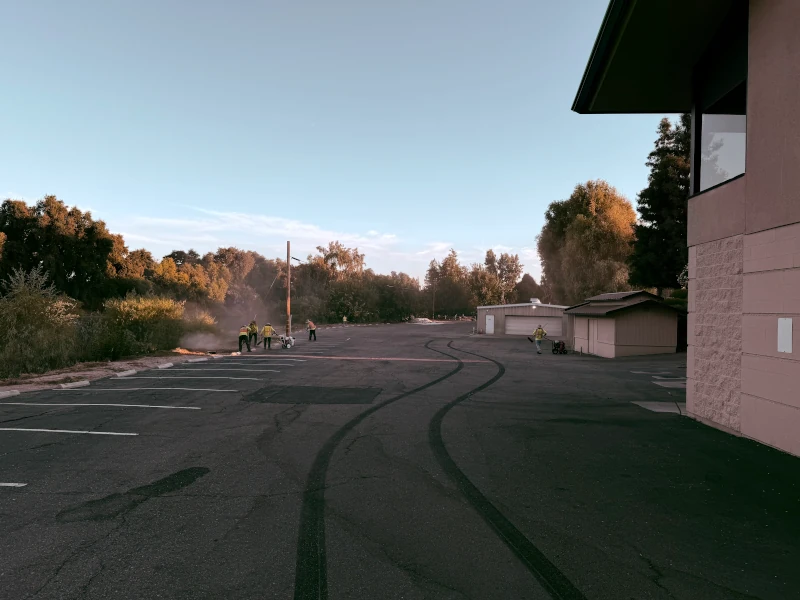 Crew cleaning parking lot before sealcoating the lot
