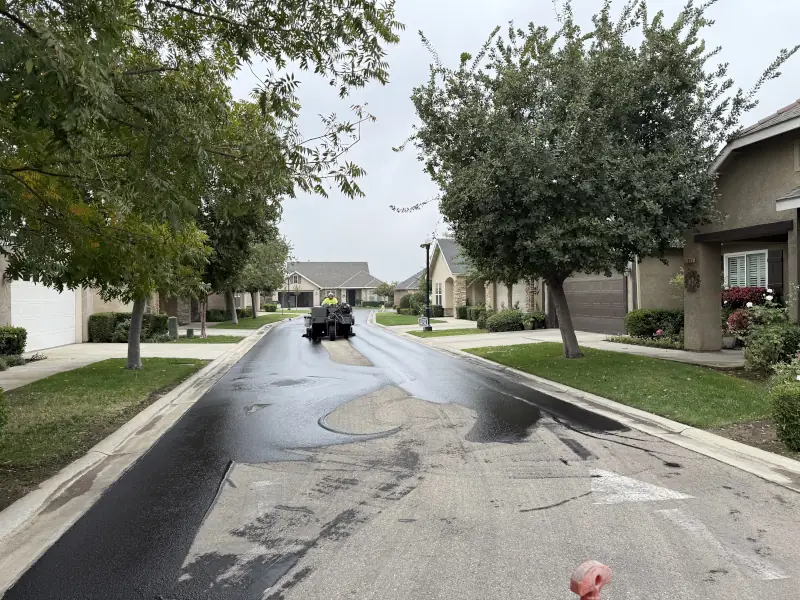 sealcoating being applied to street